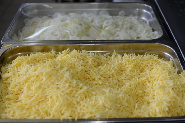 Trays of grated cheese